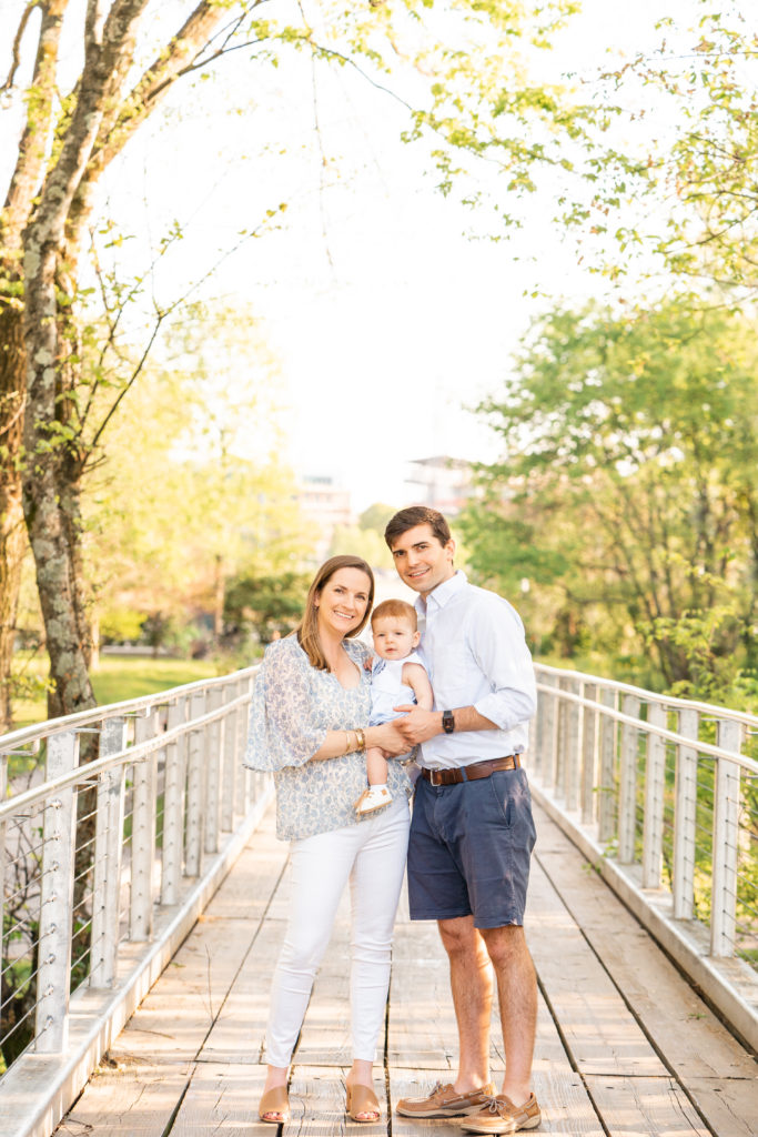 Chattanooga Family Photographer; 6 month milestone photos at Renaissance Park Chattanooga, TN - golden hour photography - Photo shoot outfits white and blue - Family of 3 posing