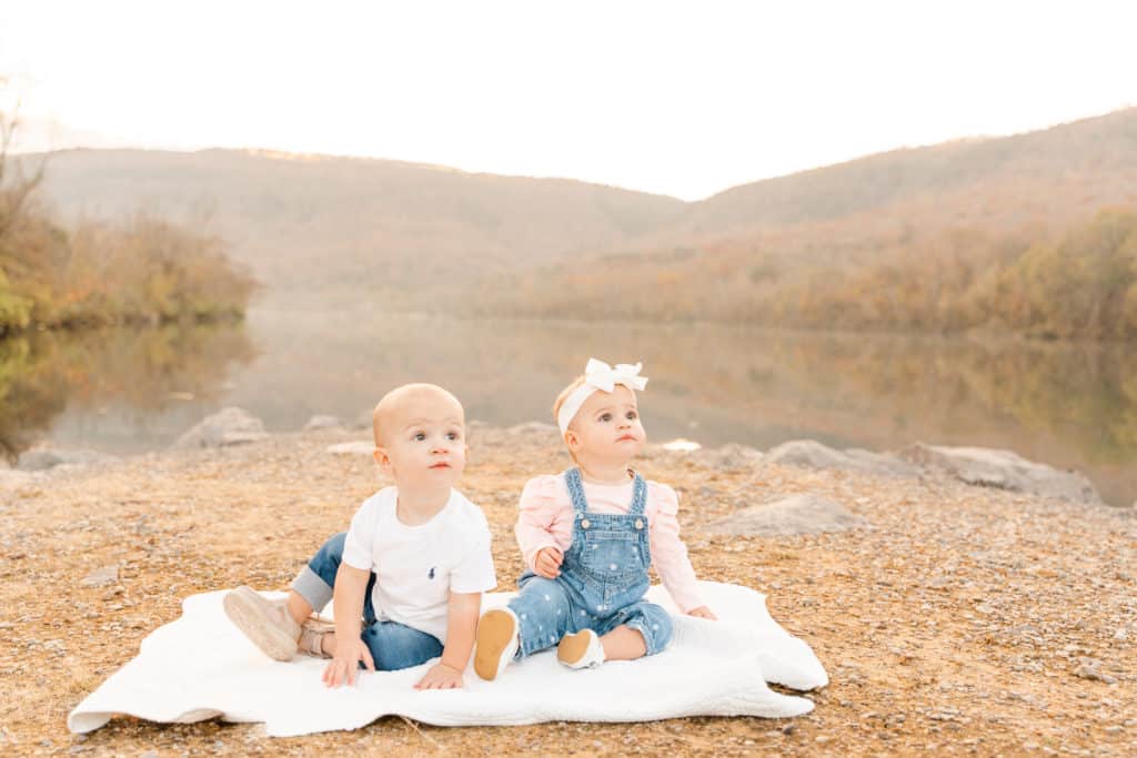One year old twins by Tennessee River during family fall photos in Chattanooga