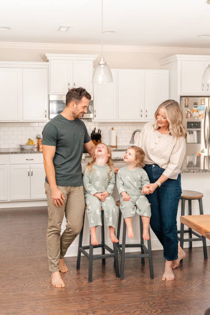 Family of 4 posing in kitchen