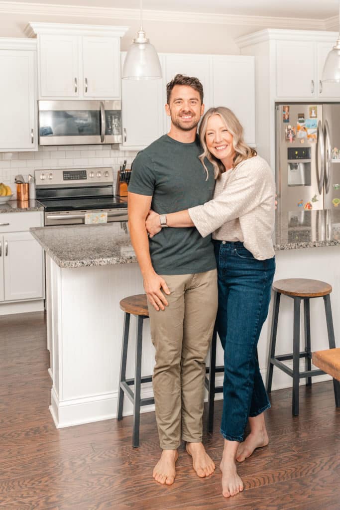 Husband and wife hugging in kitchen