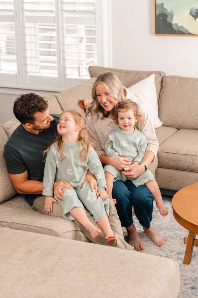 In home lifestyle session, family cuddling on couch