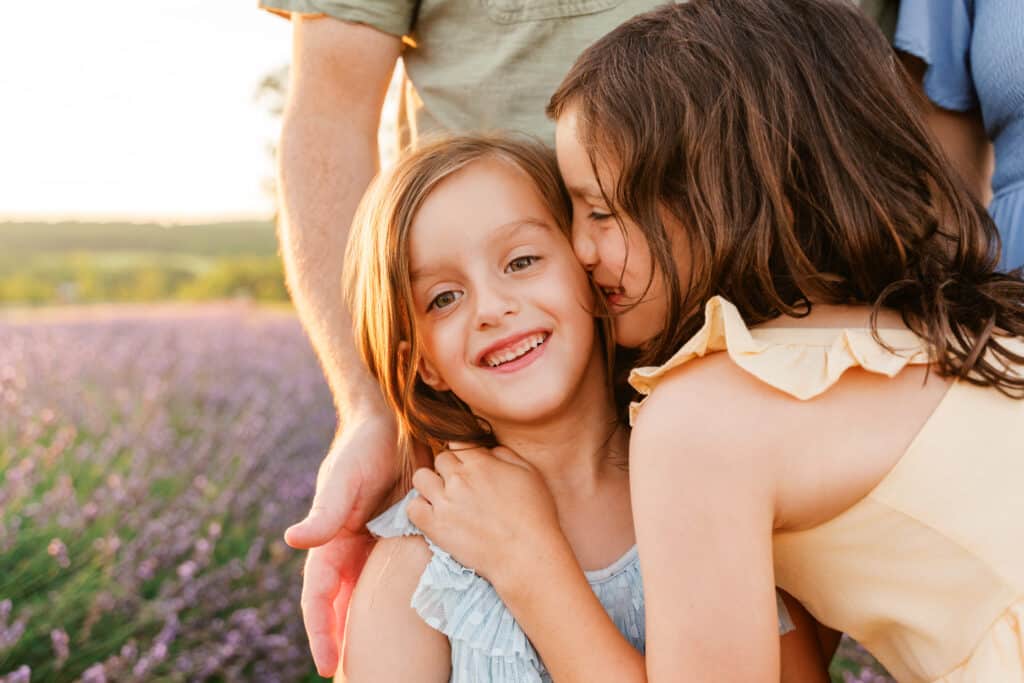 sister whisper secret during session with lifestyle photographer