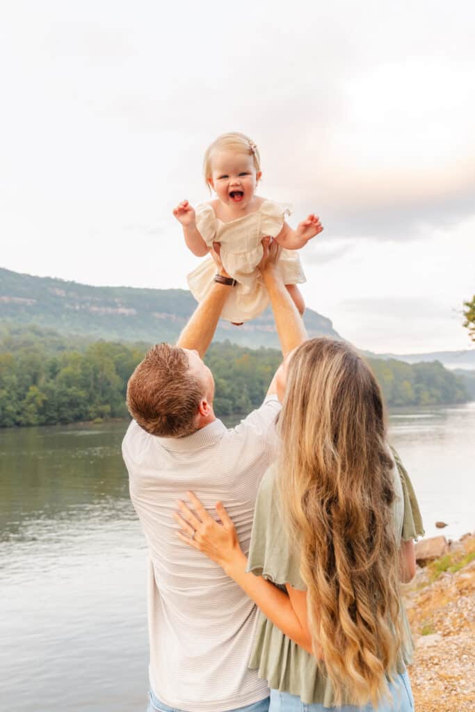 Parents play with toddler during session with lifestyle photographer