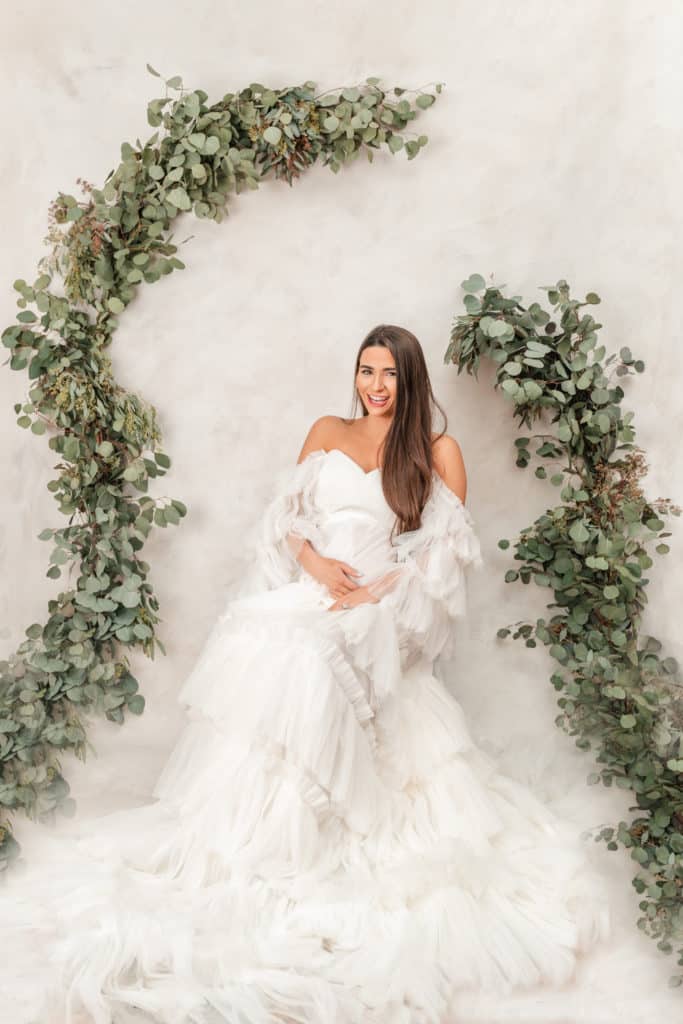 Luxury white tulle maternity gown from Salt Gowns paired with fresh Eucalyptus garland.  Etsy DIY style shoot.