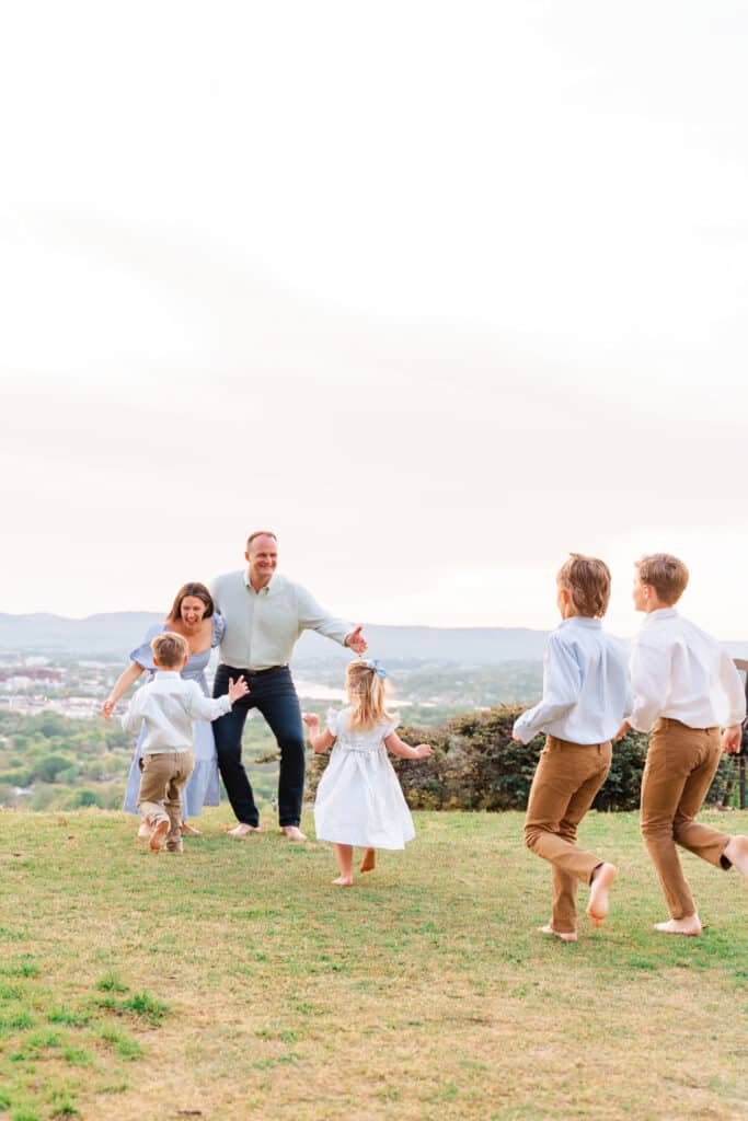 family plays together during photoshoot. 