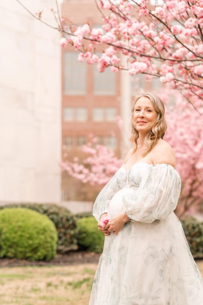Chattanooga maternity session featuring pink kwanza blossoms in downtown Chattanooga, TN.