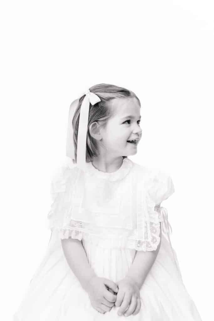 Heirloom portraits near me. Portrait of little girl in classic white dress in profile