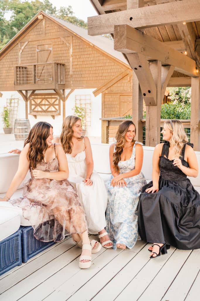 Models enjoy deck at wedding and event venue CloudTree Vineyard in Lafayette, GA during branding photoshoot. 