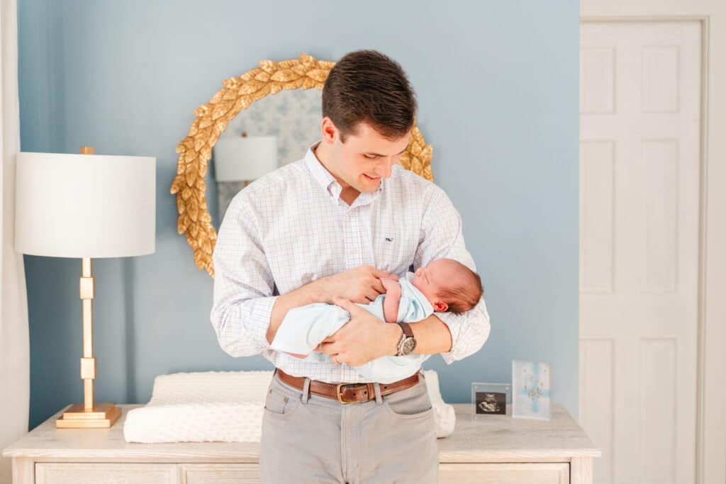 When to use flash photography during indoor sessions.  Father holds baby boy in cottage core nursery