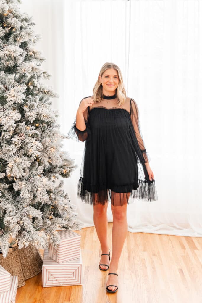 Black lace Christmas party dress worn by model during brand photography session