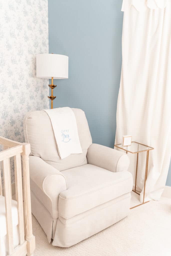 Flash photography image of rocker and monogramed blanket in baby boy's nursery