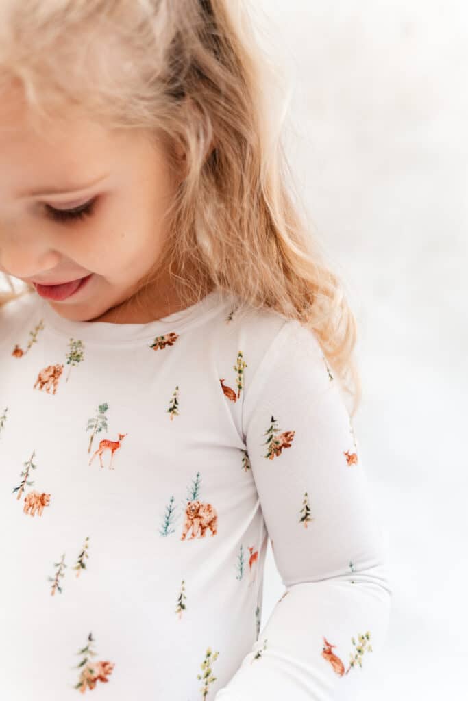 Brand photography close up of toddler wearing pajamas in front of backdrop