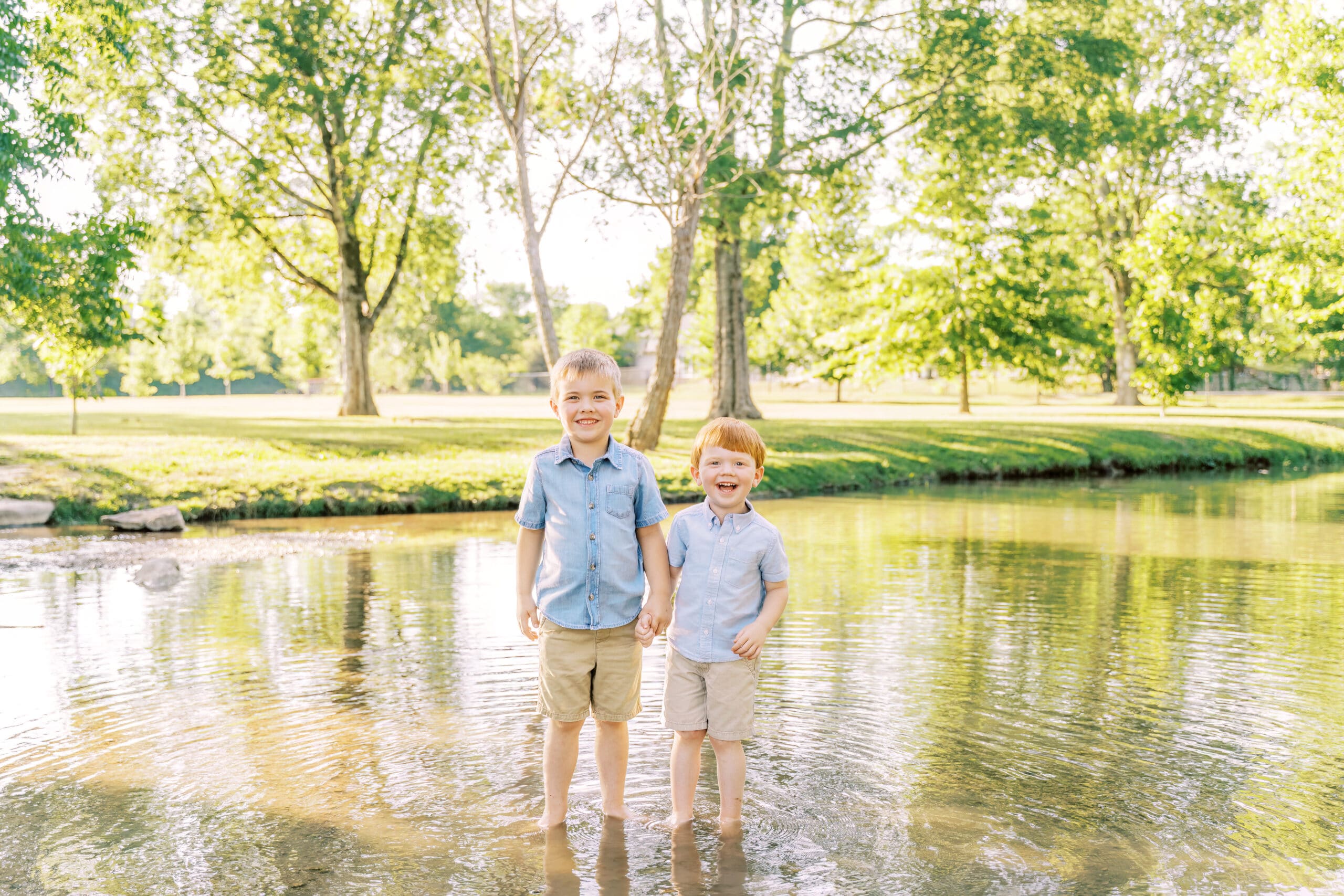 Relaxed photoshoot with two little boys playing in creek during the summer