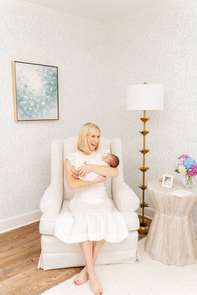 Mother laughs during newborn photography session.