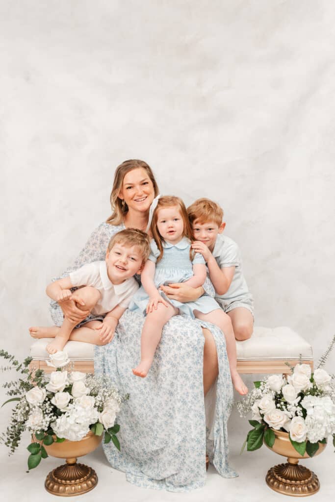 Mother poses with her children during motherhood photography session. 