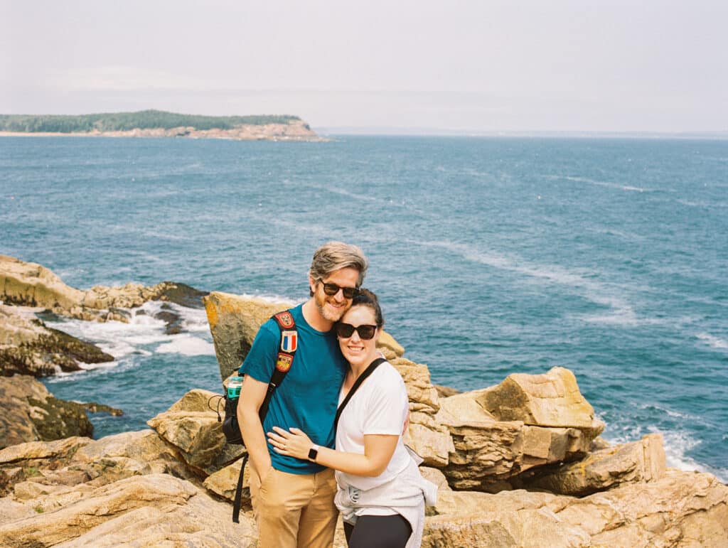 Couple poses on ocean path trail