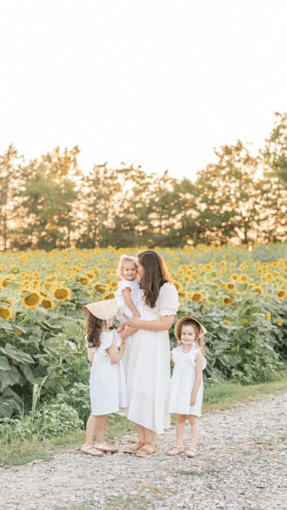 Image of mother and daughters in sunflower field