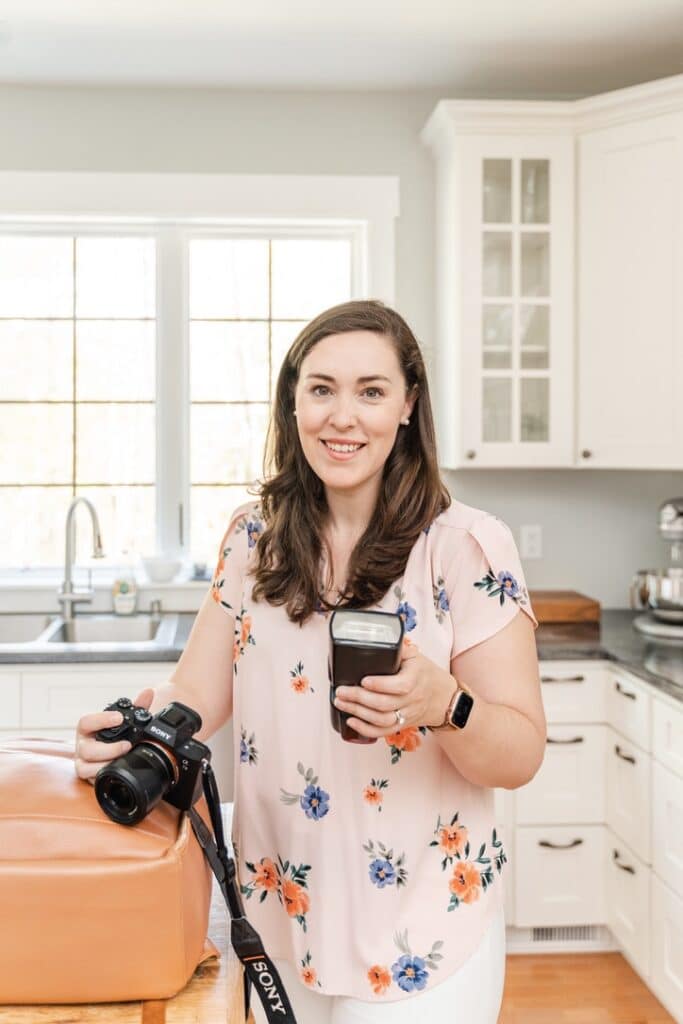 Image of photographer Kelley Hoagland holding camera and Godox V1