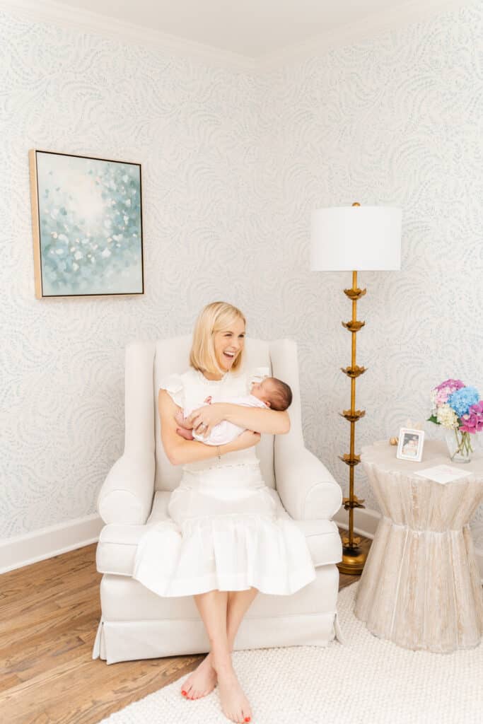 mom smiles during newborn pictures
