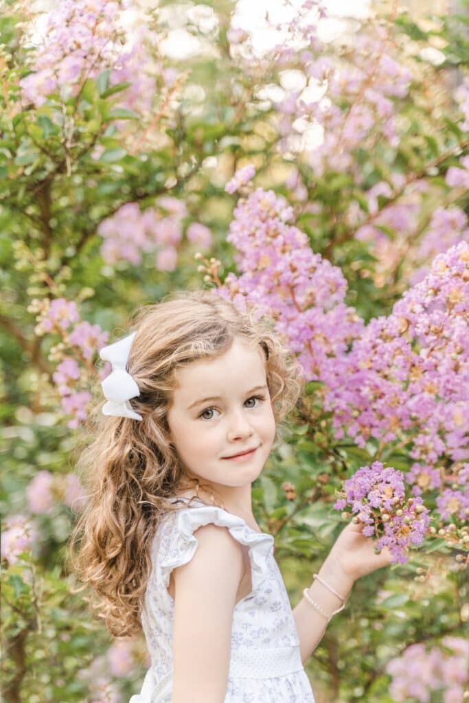 Image of little girl in front of crepe myrtle.
