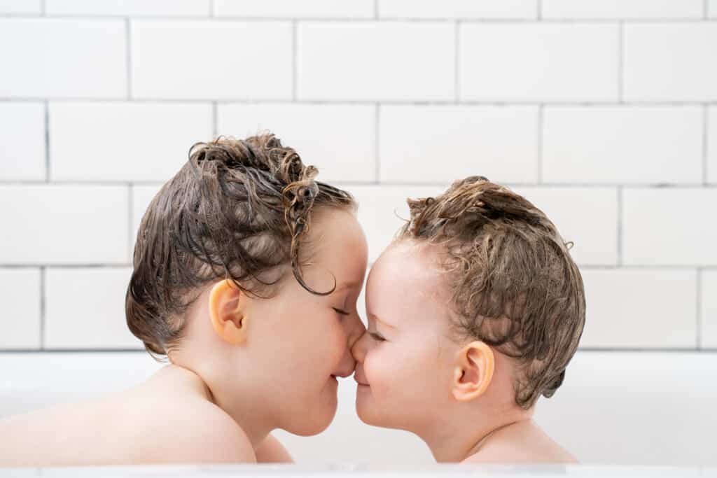Bathtub portrait of two little girls taken with natural light.