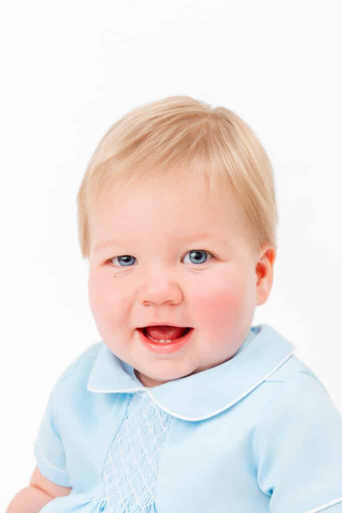 Little boy wears blue outfit in heirloom photos.