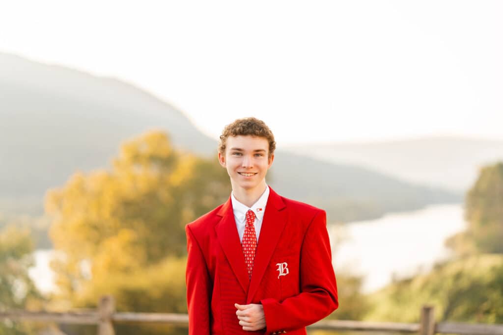 Boy smiles at camera for senior pictures at Baylor School